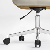 Eureka Ergonomic Close-up of off-white faux leather office chair base with polished chrome five-star design, black casters, and lever.