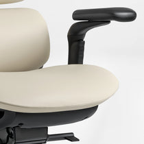 Eureka Ergonomic Light beige Forma ergonomic chair PU leather seat cushion and black armrest detail, showing stitching and matte finish.