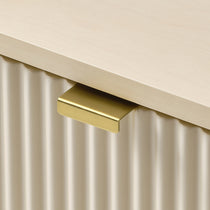 Eureka Ergonomic Opal file cabinet brass pull detail, close-up of the tab handle on the fluted drawer front
