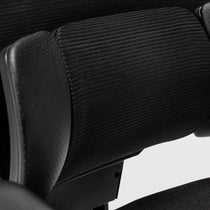 Eureka Ergonomic Typhon II chair headrest with perforated material and textured black fabric back support.