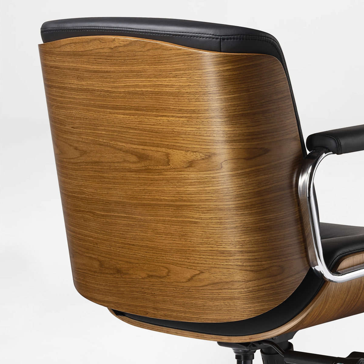 Eureka Ergonomic close-up of the black Mathias Mason chair's curved walnut wood back shell