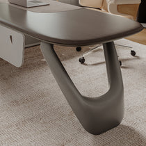Eureka Ergonomic Zen Orion executive desk close-up: dark gray textured finish, elliptical wood-grain top, curved metallic leg.