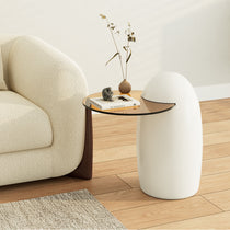 Modern White Penguin Side Table With Amber Glass Top, Next to Cream Sofa. Text On the Table Is 'My Residence'.