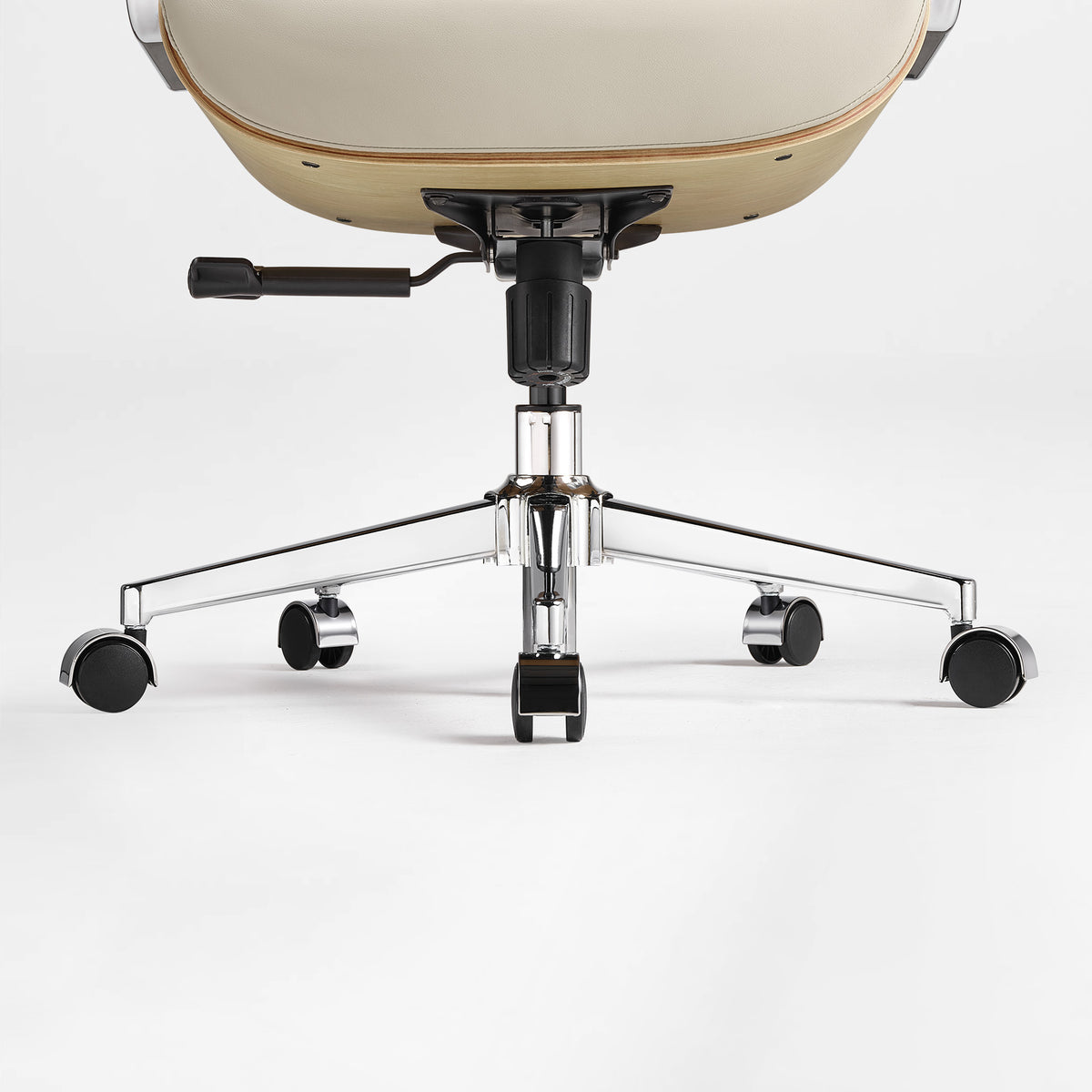 Eureka Ergonomic close-up of the beige Mathias Mason chair's chrome base, gas lift, and caster wheels