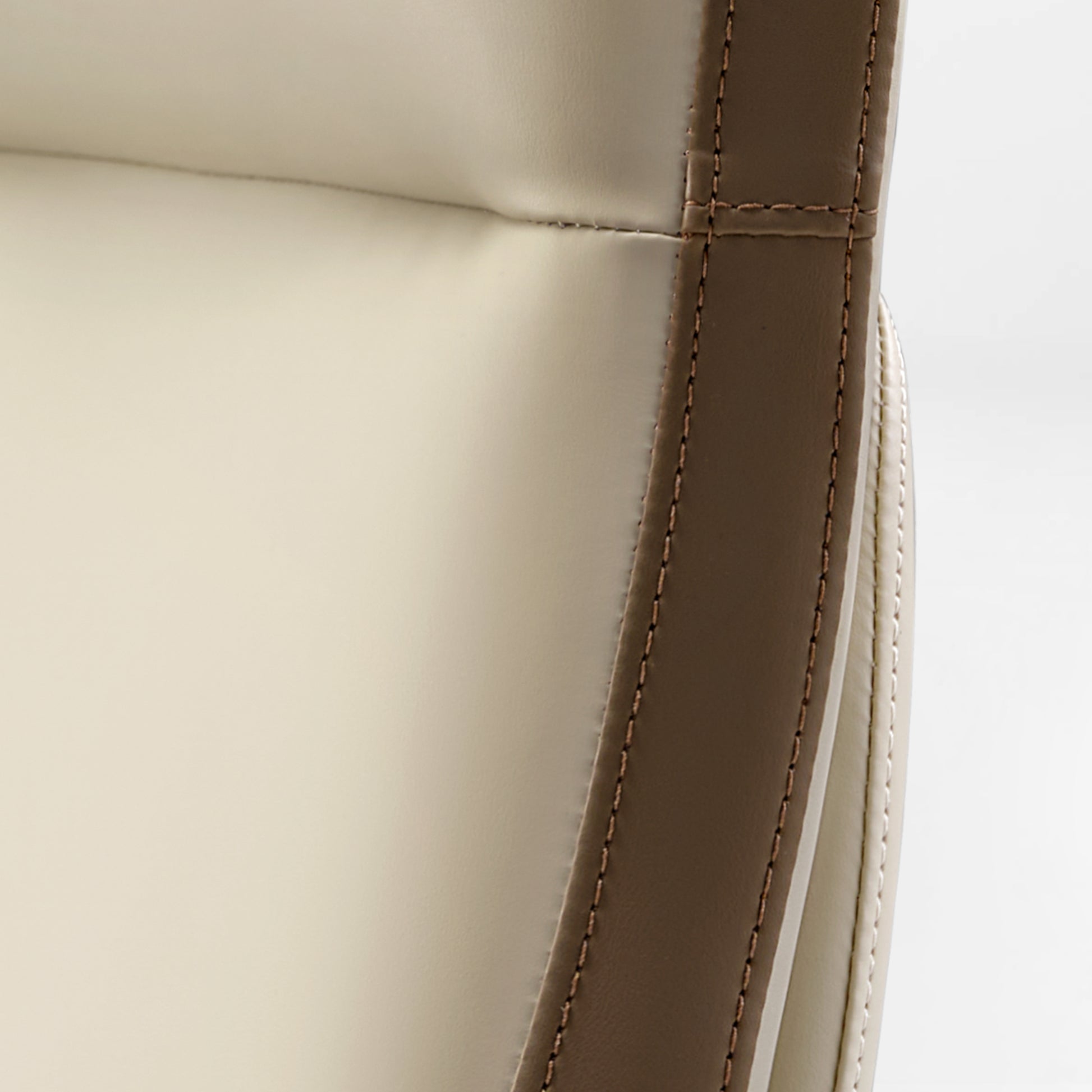 Eureka Ergonomic Close-up of Alto executive chair showing cream and taupe silicone leather stitching detail.