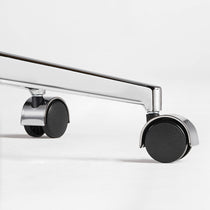 Eureka Ergonomic close-up of a caster wheel and polished metal base on the brown Mathias Mason chair