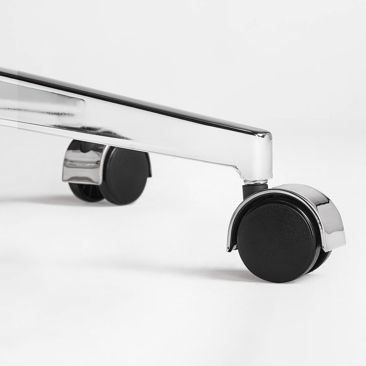 Eureka Ergonomic close-up of a caster wheel and polished metal base on the beige Mathias Mason chair