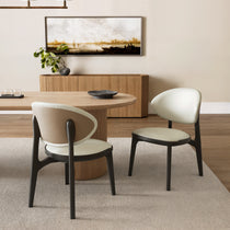 Off-White Leather Cedar Dining Chairs With Woven Back and Dark Wood Frame in a Modern Dining Space.