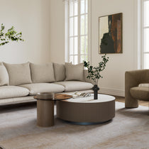 Modern Round Sintered Stone Coffee Table Set in a Living Room, With a Beige Sofa and Armchair.
