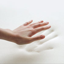 Hand Pressing Into Soft White Eco-Fabric of the Modern Lounge Chair, Showcasing Comfort.