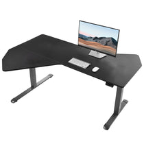Eureka Ergonomic Blossom Dynamics black wood grain L-shaped standing desk with computer setup in a home office.