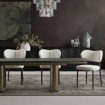 Eureka Ergonomic Savoy extendable black sintered stone dining table with bronze base and chairs.