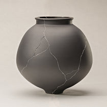 Dark Gray Ceramic Vase With Silver Crack Detailing, Perfect for Dining Table Decor.