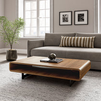 Eureka Ergonomic 47 Walnut Rounded Rectangular Coffee Table in a Living Room Setting, Walnut Wood Grain.