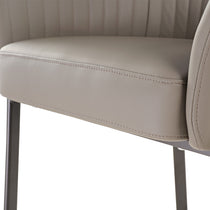 Close-Up of Jade Upholstered Armchair Detail. Stitching, Premium Textured Fabric, Dark Metal Legs, Retro-Modern Design.