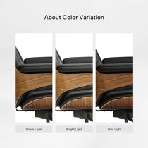 Eureka Ergonomic Mathias black leather ergonomic executive chair showcasing color variation under warm, bright, and dim light, with wood veneer shell.