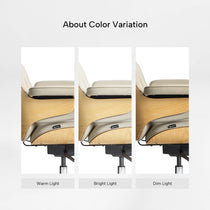 Eureka Ergonomic Mathias executive chair: light beige Napa leather & wood veneer color variation under warm, bright, dim light.