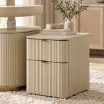 Eureka Ergonomic Opal fluted file cabinet in Cream styled on a shag rug with books and an olive branch vase