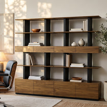 Eureka Ergonomic Ark 78 inch walnut bookshelf with drawers and display shelves, styled in a modern room