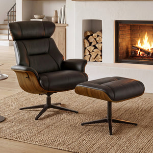 Eureka Ergonomic Matteo black leather lounge chair and ottoman beside a fireplace