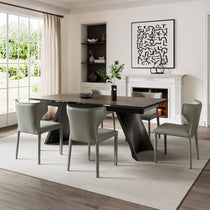 Gray Leather Dining Chairs Set Around a Modern Dining Table in a Well-Lit Dining Space.