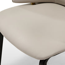 Juliet Dining Armchair Detail: Cream Upholstered Seat, Gold Accents, Black Legs. Modern Design.