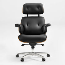 Eureka Ergonomic Mathias black Napa leather executive office chair with button tufting and wood veneer accents on a silver five-wheel base.