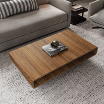 Eureka Ergonomic 47 Walnut Rounded Rectangular Coffee Table in a Living Room Setting, With Marc Hom Book On Top.