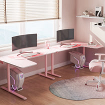 Pink L-Shaped Gaming Desk Setup With Two Monitors, White Gaming Chair, and a Cat Paw Mousepad - Ergonomic Gaming Setup.