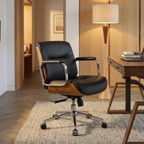Eureka Ergonomic black Mathias Mason low back office chair styled in a warm wood-paneled study