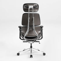 Eureka Ergonomic Rear view of Forma ergonomic executive chair with dark gray PU leather and curved aluminum back frame.