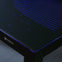 Eureka Ergonomic GTG L-shaped gaming desk corner, blue wave LED lighting, starry effect, black glass.
