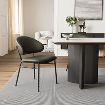 Finn Dining Chair in Green Faux Leather With Black Steel Legs in a Modern Dining Room Setting.