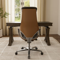 Eureka Ergonomic Serene Aaron brown genuine leather executive office chair with chrome base, shown in a modern office setting.