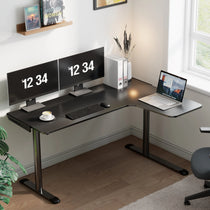 Black L-Shaped Gaming Desk With Monitors Displaying Time 12: 34, Laptop Setup, and Carbon Fiber Surface, Ergonomic Design.