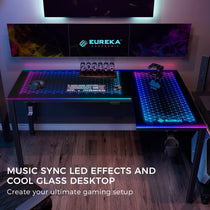 L-Shaped Eureka Ergonomic GTG-L60 Gaming Desk With Rgb Lighting, Glass Surface, and Music Sync Effects.