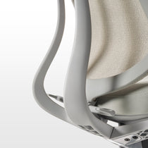 Eureka Ergonomic Lira ergonomic office chair detail: light gray frame, beige mesh back, adjustable lever. Modern design.