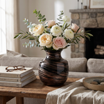 Eureka Ergonomic dark vase with white floral arrangement