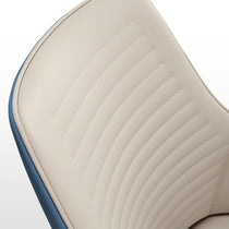 Juliet Dining Armchair Detail: Cream Upholstered Seat With Stitching, Brown and Blue Accents. Modern Dining Chair Design.