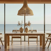 Eureka Ergonomic Edora Oak Extendable Dining Table with minimalist design and clean lines, set in a dining room with ocean view.