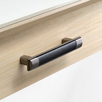 Eureka Ergonomic Ark Pro Desk Drawer Handle Detail: Black Leather Grip and Wood Grain Accent, Luxury Desk Design.