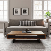 Walnut Rounded Rectangular Coffee Table in a Living Room Setting With a Gray Sofa, Book Reads Marc Hom Profiles.
