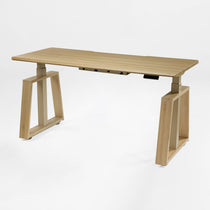 Eureka Ergonomic Ark Lite standing desk with light woodgrain top and beige trapezoidal legs.