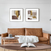 Set of 2 Abstract Framed Wall Art With Gold, Brown, and Neutral Tones, Above a Brown Leather Sofa, WA-02.