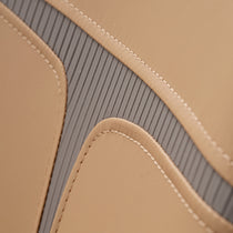 Turmeric Leather Couture Dining Chair Detail, Showing Stitching and Gray Accents.