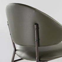 Finn Dining Chair Backrest in Olive Green Faux Leather With Steel Frame Detail.
