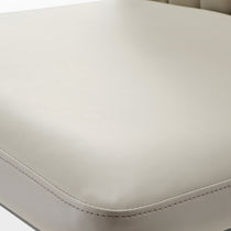 Off-White Leather Dining Chair Upholstery Detail With Stitching. Minimalist Design.