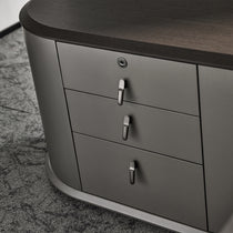 Eureka Ergonomic Zen Orion executive desk detail: dark wood grain top and dark gray drawers with metallic handles and keyhole.
