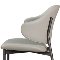 Noble Gray Upholstered Dining Chair Detail, Showcasing the Curved Backrest and Metal Legs.