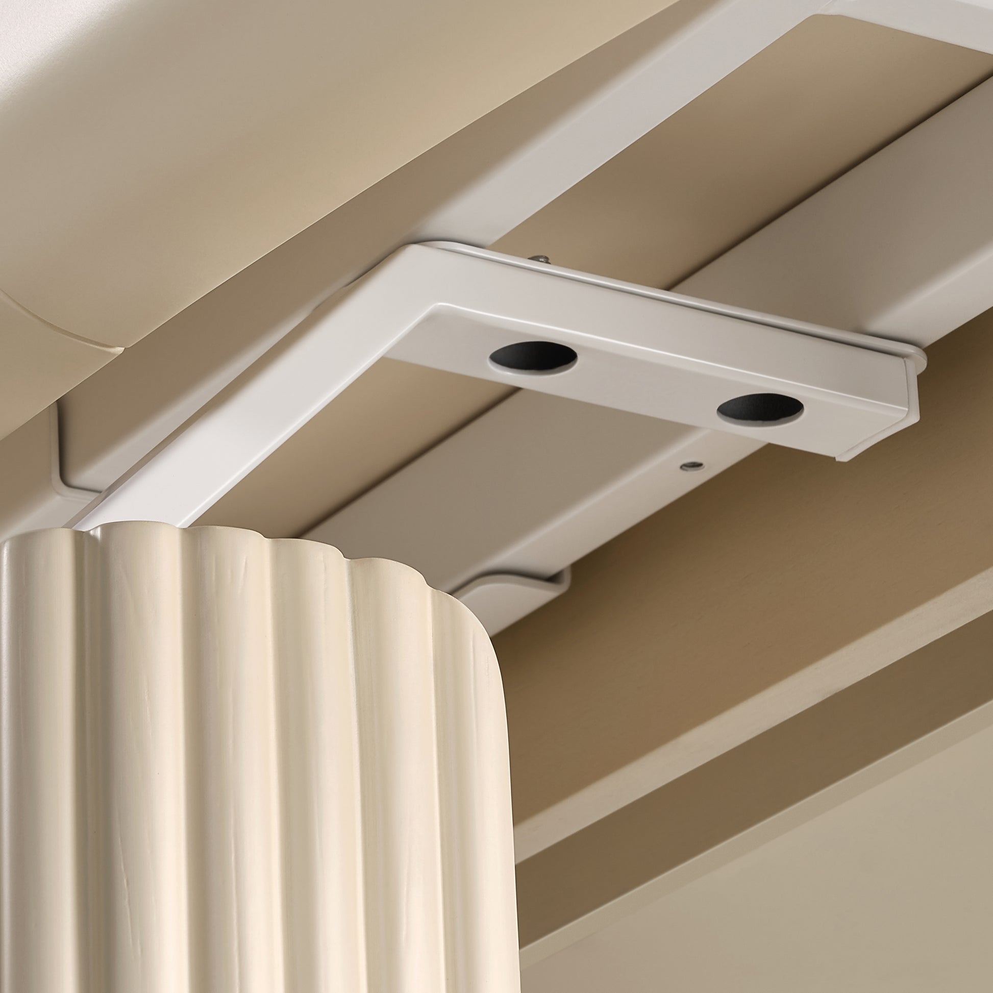 Close-up of Cream Birch Opal Modesty Panel securely installed under the desk with sturdy metal brackets.